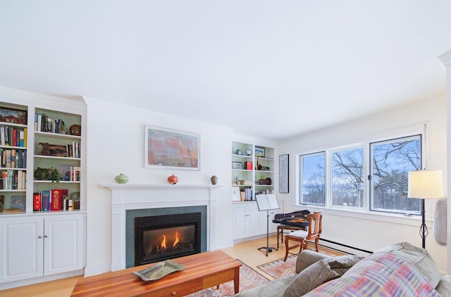 living room with a baseboard heating unit, built in features, and light hardwood / wood-style floors