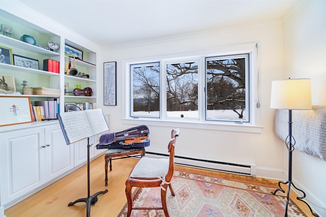 home office featuring ornamental molding, a baseboard radiator, and light hardwood / wood-style flooring