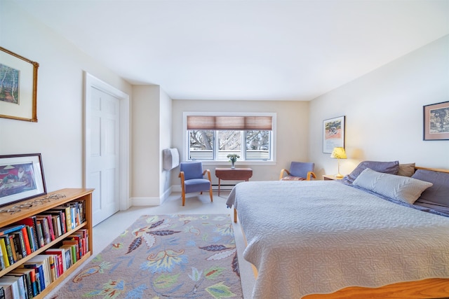 carpeted bedroom with a baseboard radiator