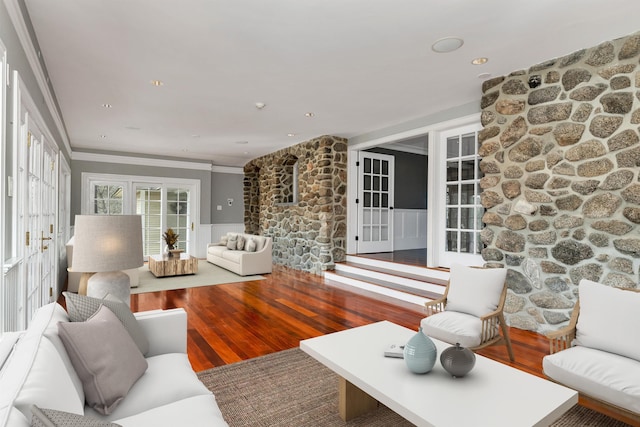 living room with wood-type flooring and ornamental molding