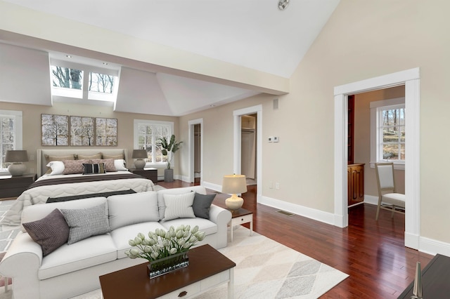 bedroom featuring dark hardwood / wood-style flooring and high vaulted ceiling