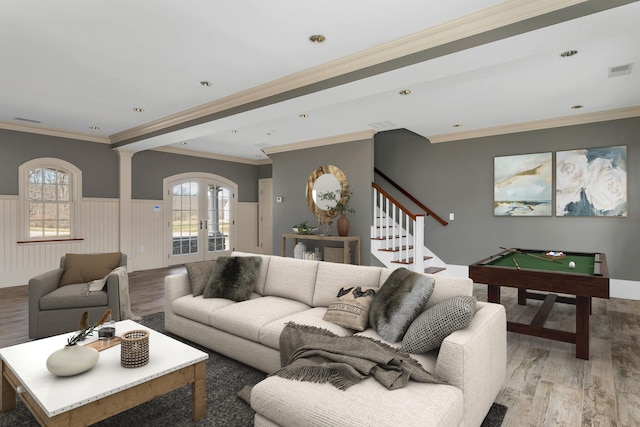 living room with french doors, ornamental molding, a wealth of natural light, and light wood-type flooring