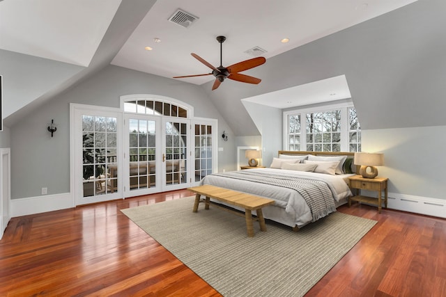 bedroom with vaulted ceiling, a baseboard radiator, ceiling fan, and hardwood / wood-style floors