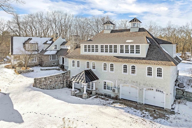 view of front of house featuring a garage and central AC