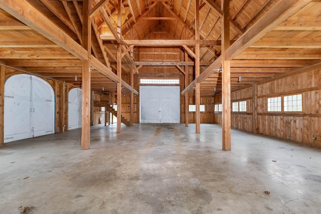 interior space featuring lofted ceiling and concrete floors