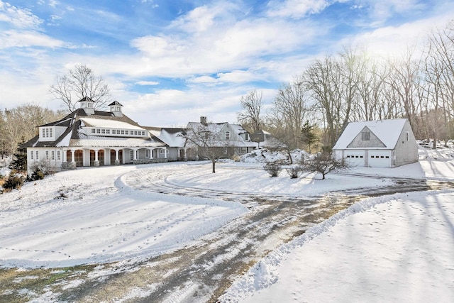 snowy yard featuring a garage