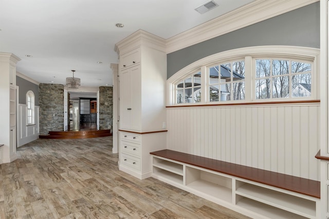 mudroom featuring crown molding and light hardwood / wood-style floors