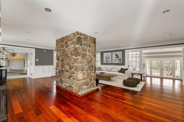 living room with crown molding, hardwood / wood-style floors, baseboard heating, and french doors