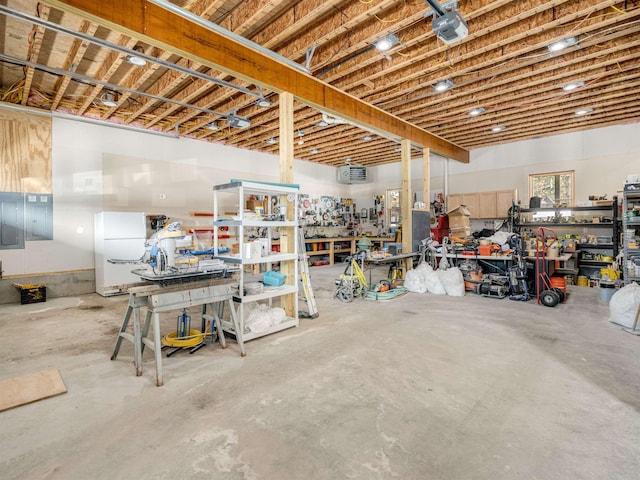 basement featuring a workshop area and white refrigerator