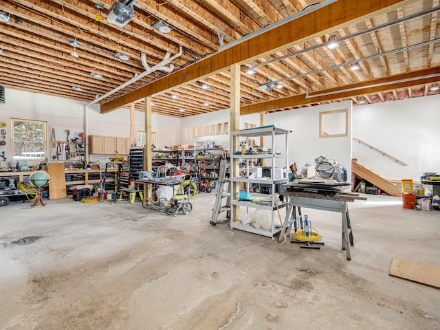 garage with a workshop area and a garage door opener