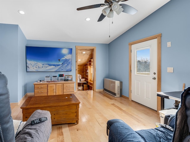 living room featuring ceiling fan and light hardwood / wood-style floors