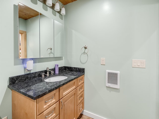 bathroom featuring vanity, heating unit, and wooden ceiling