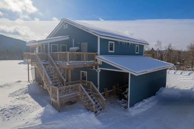 snow covered property featuring a wooden deck