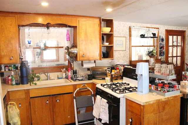 kitchen featuring gas range oven and sink