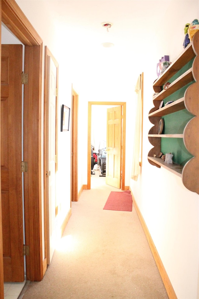 hallway featuring light carpet