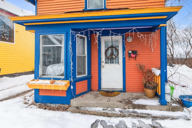 view of snow covered property entrance