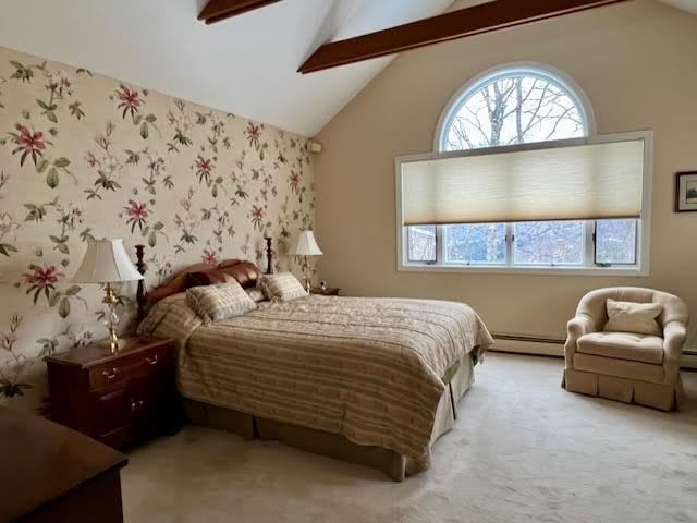 carpeted bedroom featuring vaulted ceiling with beams and a baseboard radiator