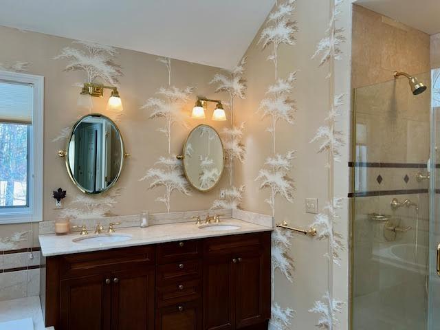 bathroom with vanity and a shower with shower door