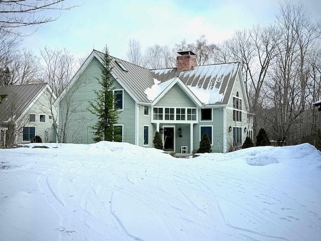 view of snow covered back of property