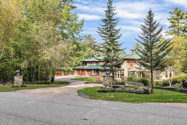 view of front of house with a garage and a front yard