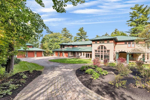 view of front of home featuring an outbuilding, a garage, and a front yard