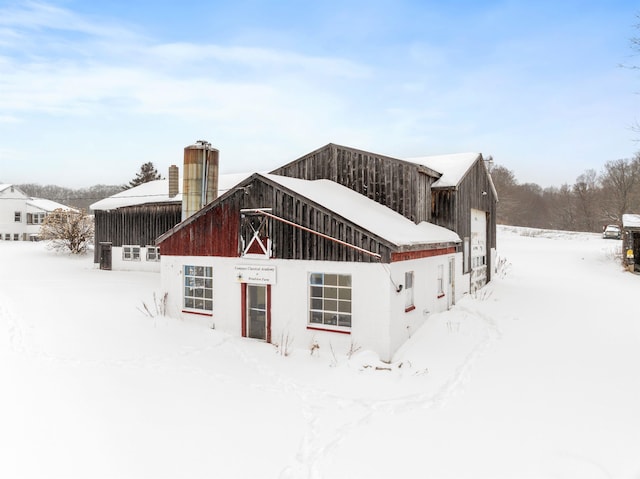 view of snow covered back of property