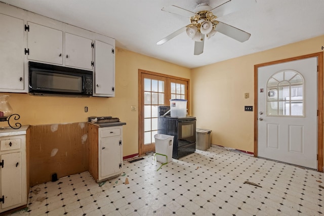 kitchen with white cabinetry and ceiling fan