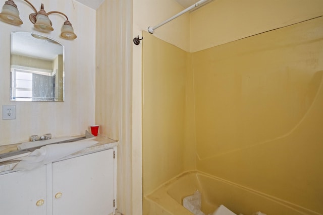 bathroom with vanity and shower / washtub combination