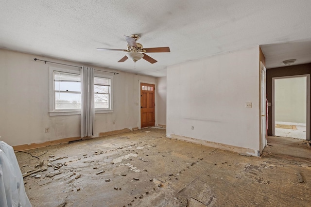 spare room with a textured ceiling and ceiling fan