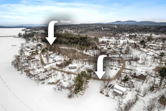 snowy aerial view with a mountain view