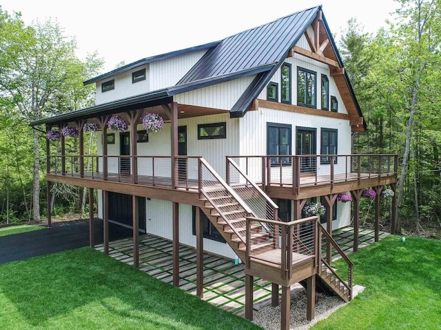 back of house featuring a wooden deck and a yard