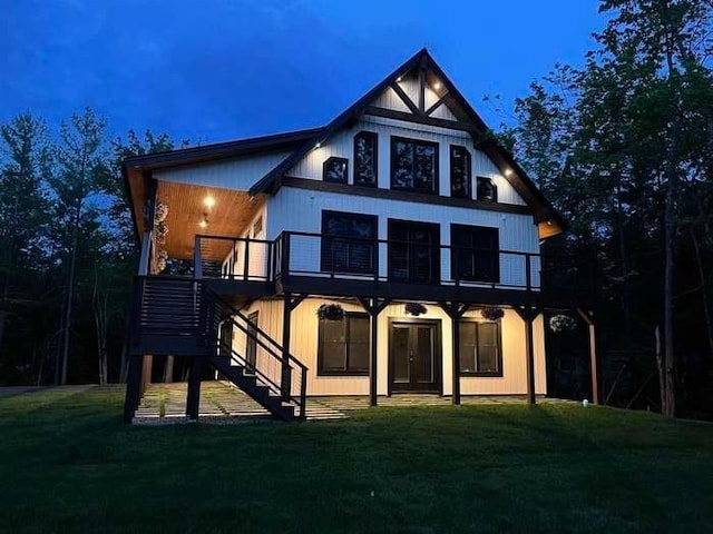 back of house featuring a wooden deck and a yard