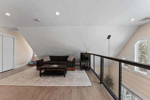 living room featuring vaulted ceiling and light hardwood / wood-style floors