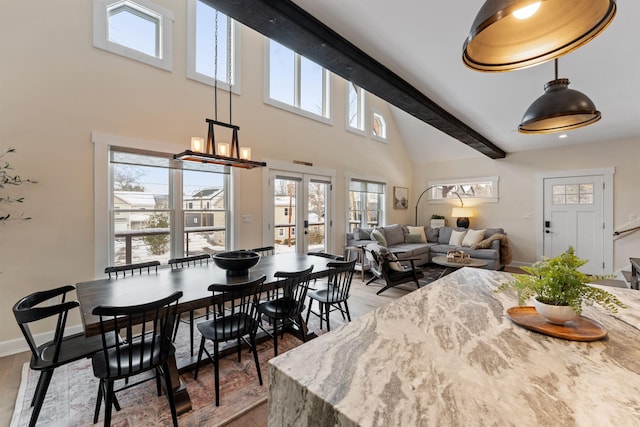 dining area with hardwood / wood-style floors, beam ceiling, high vaulted ceiling, and french doors