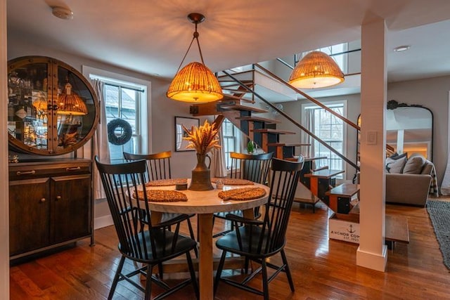 dining area featuring plenty of natural light and dark hardwood / wood-style floors