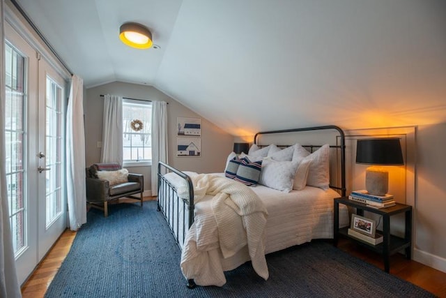 bedroom featuring french doors, lofted ceiling, and wood-type flooring