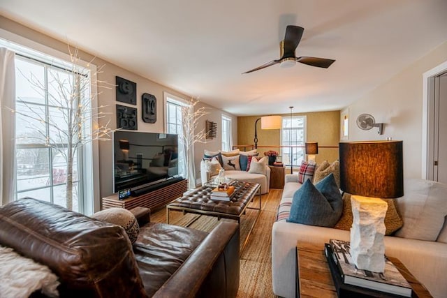 living room with hardwood / wood-style flooring and ceiling fan