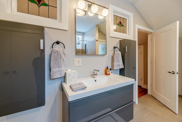 bathroom with vanity and vaulted ceiling