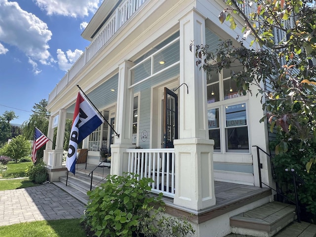 view of side of property with covered porch