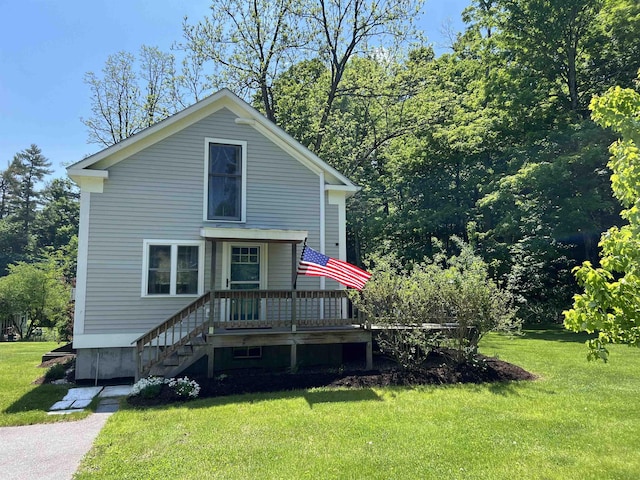 view of front of house with a deck and a front lawn