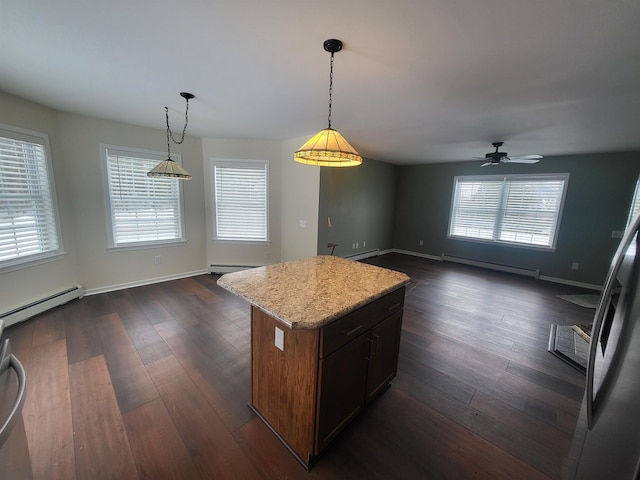 kitchen featuring a kitchen island, dark wood-type flooring, hanging light fixtures, and a baseboard heating unit