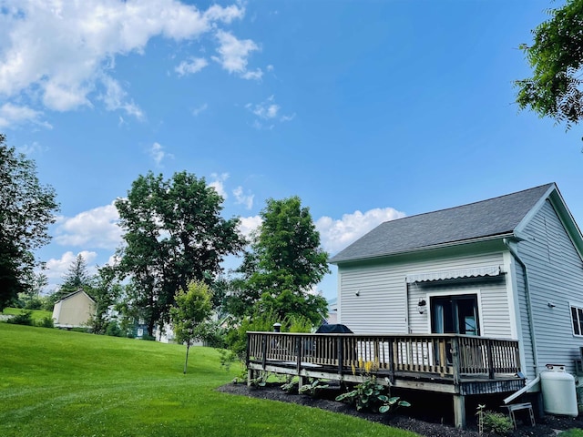 rear view of property with a deck and a lawn