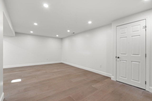 basement with light hardwood / wood-style floors