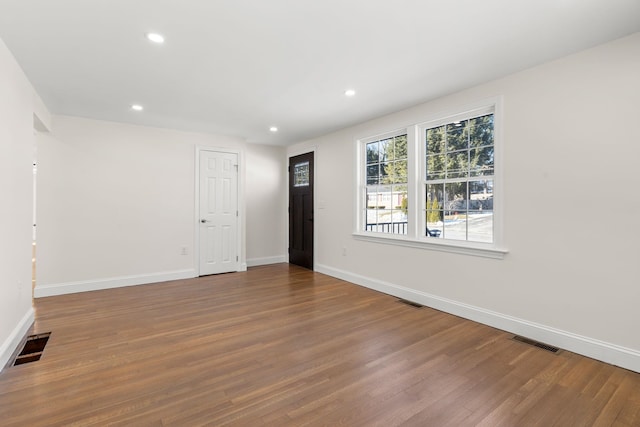 unfurnished room featuring hardwood / wood-style flooring