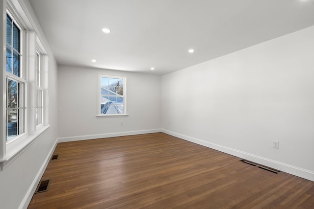 unfurnished room with dark wood-type flooring