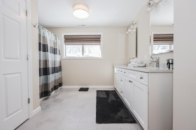 bathroom with plenty of natural light and vanity