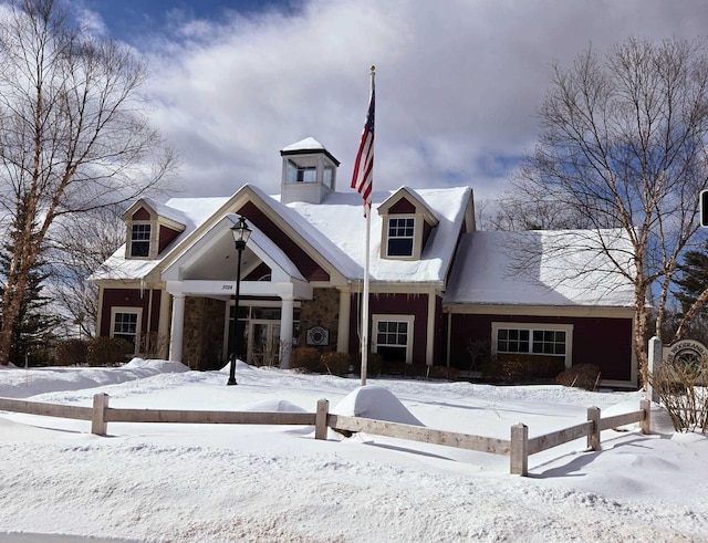 view of snow covered back of property