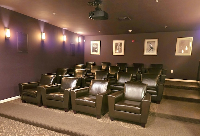 home theater room featuring light colored carpet