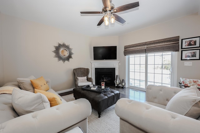 living room featuring ceiling fan and wood-type flooring