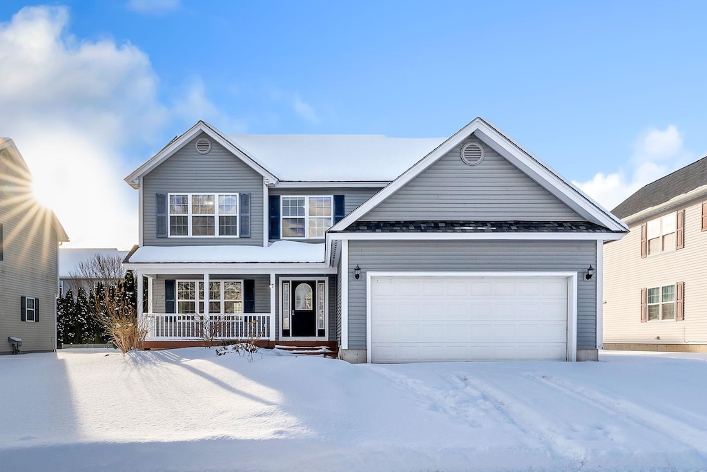 view of front of property featuring a porch and a garage